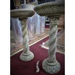 Two reconstituted stone bird baths, on barley twist supports with acanthus leaf spreading bases, H.