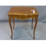 A French walnut serpentine side table, the quarter veneered top with two drop leaves, having