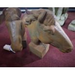 A pair of cast iron horse heads, on square bases, H.30cm (2)