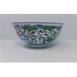 A Chinese doucai bowl, decorated with scrolling foliage, bearing six character marks within two blue