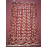 An antique Russian Tekkeh Bokhara rug, repeating elephant pad motifs on a red field, within