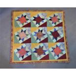 A quilted patchwork wall hanging embroidery, 'Drunken Stars', with label for 'Kris Evans'