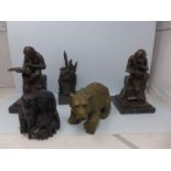 A collection of bronze animals, including two reading monkeys, a bear, a mouse, and a group of