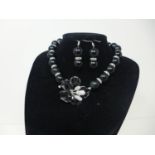 A black onyx beaded necklace, set with cubic zirconia and with floral pendant, together with