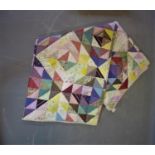 A vintage patchwork quilt, with diamond medallions with floral motifs, 240 x 145cm