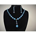 An aquamarine beaded necklace together with a pair of aquamarine and faux pearl earrings