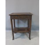 An early 20th century side table, with lower tier, on outswept feet