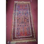 A North-East Persian Beluchi runner, geometric motifs on a rouge field, within geometric borders,