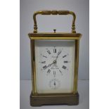 A French L'Epee Looping gilt brass carriage clock, with repeating button, white dial with Roman