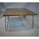 A stud bound copper top low table, on hairpin legs, H.38 W.70 D.70cm