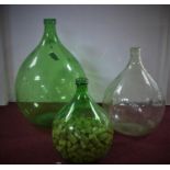 Three large glass bottles/carboys, one filled with corks, H.67cm (largest)