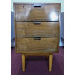 A Hille walnut chest of three short drawers, on tapered legs, label to interior, H.77 W.46 D.46cm