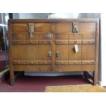 A vintage 1950's oak sideboard in the antique style fitted drawers and cupboards on block feet. H.