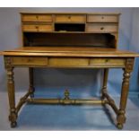 A late 19th oak desk, raised back with an arrangement of five drawers and shelf, above two short