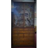 A 19th century mahogany bureau bookcase, with dentil cornice, astragal glazed doors and above bureau