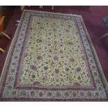A Persian Tabriz carpet, with all-over hunting, palmette and vine design on a fawn ground, with