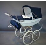 A Silver Cross Heritage toy pram with navy hood, bearing maker's mark and label, H.97 W.46 D.97cm