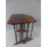 A nest of three Regency style mahogany and crossbanded occasional tables