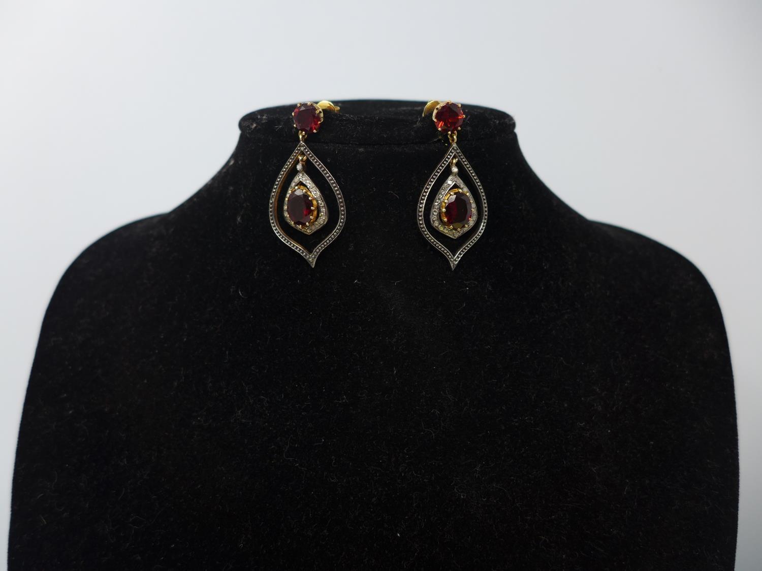 A pair of earrings set with garnets and diamonds, stamped 585 (14ct), and 925 (silver), boxed