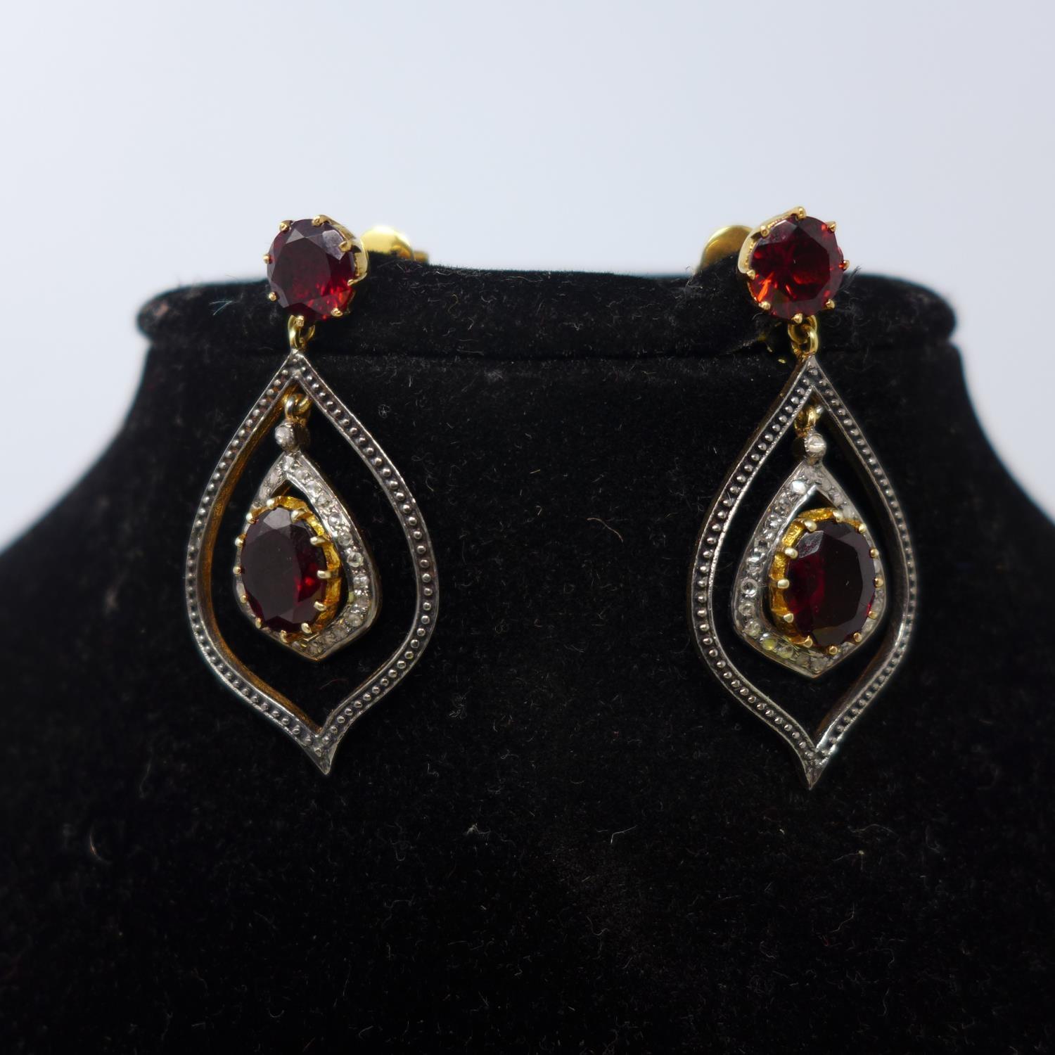 A pair of earrings set with garnets and diamonds, stamped 585 (14ct), and 925 (silver), boxed - Image 2 of 3