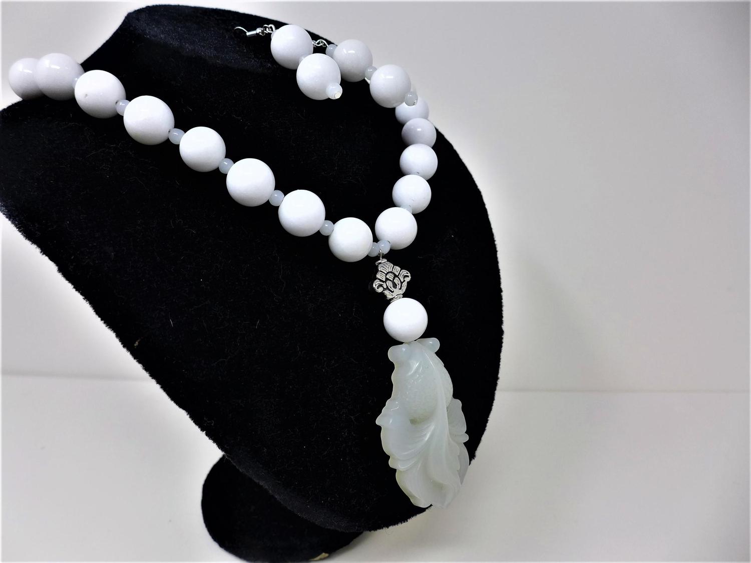 A white jadeite beaded necklace with pendant, together with a pair of white jadeite beaded earrings