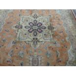 A Persian Heriz carpet, with Serapi design on a peach field, within corresponding spandrels and