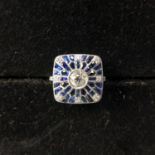 An Art Deco style platinum, sapphire and diamond fancy ring, set with a central old-cut diamond,