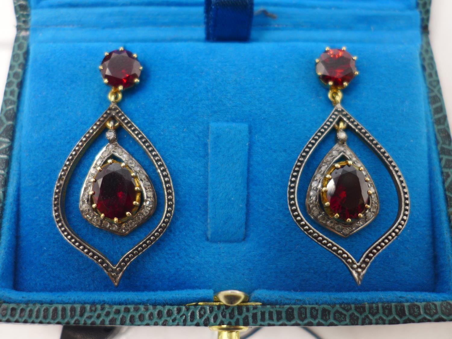 A pair of earrings set with garnets and diamonds, stamped 585 (14ct), and 925 (silver), boxed - Image 3 of 3