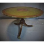 An exotic hardwood and brass mounted circular centre table, with green leather skiver with brass