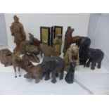A collection of hardwood carvings, mostly Chinese, to include animals, deities and figures, a