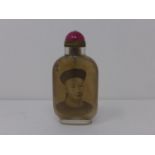 A Chinese reverse painted glass snuff bottle, decorated with bust of a man to obverse and with