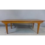 A Danish hardwood coffee table, raised on tapered legs, H.36 W.107 D.41cm
