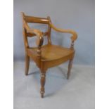 A 19th century mahogany and fruitwood solid seat desk chair, with scroll arms and floral carved back