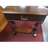 A 20th century mahogany side table, with single drawer, on heart shaped supports, on bun feet joined