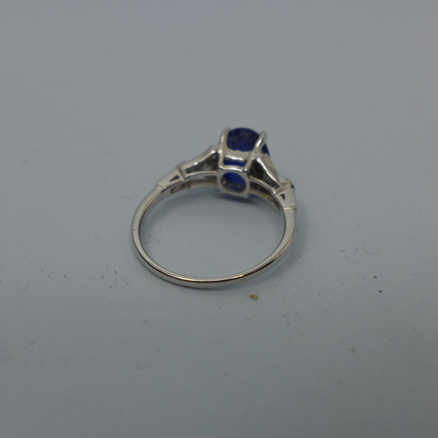 A platinum ring set with translucent blue oval double cabochon sapphire and 10 colourless - Image 3 of 5