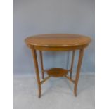 An early 20th century mahogany oval top occasional table, with under tier, raised on outswept