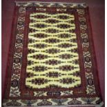 A North-East Persian Yamut rug, repeating stylised geometric motifs on an ivory field,