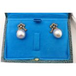 A pair of grey pearl drop earrings set with diamond bow tops, boxed