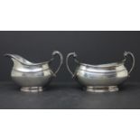 An Edwardian silver milk jug and matching twin handled sugar bowl, by Sibray, Hall & Co Ltd (Charles