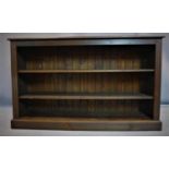 A large oak open bookcase, on pedestal base, H.93 W.153 D.31cm