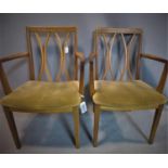 Two G-plan teak carver dining chairs, bearing maker's labels