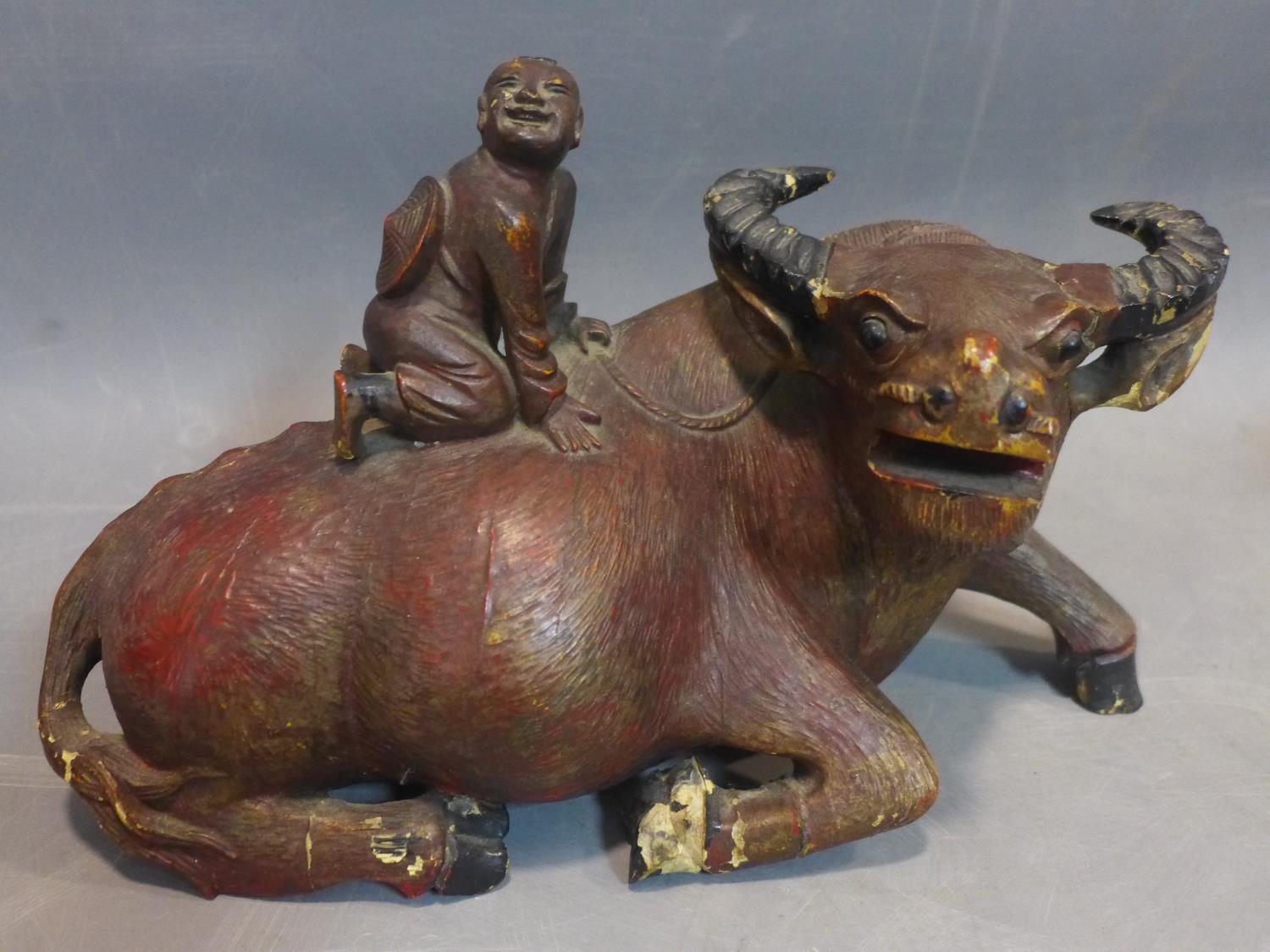 Two Chinese wooden sculptures of a child riding on water buffalo, second half 19th century - Image 2 of 4