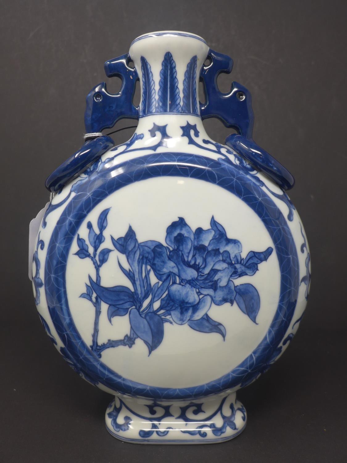 A Chinese blue and white twin handled moon flask, decorated with circular panel depicting a