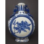A Chinese blue and white twin handled moon flask, decorated with circular panel depicting a