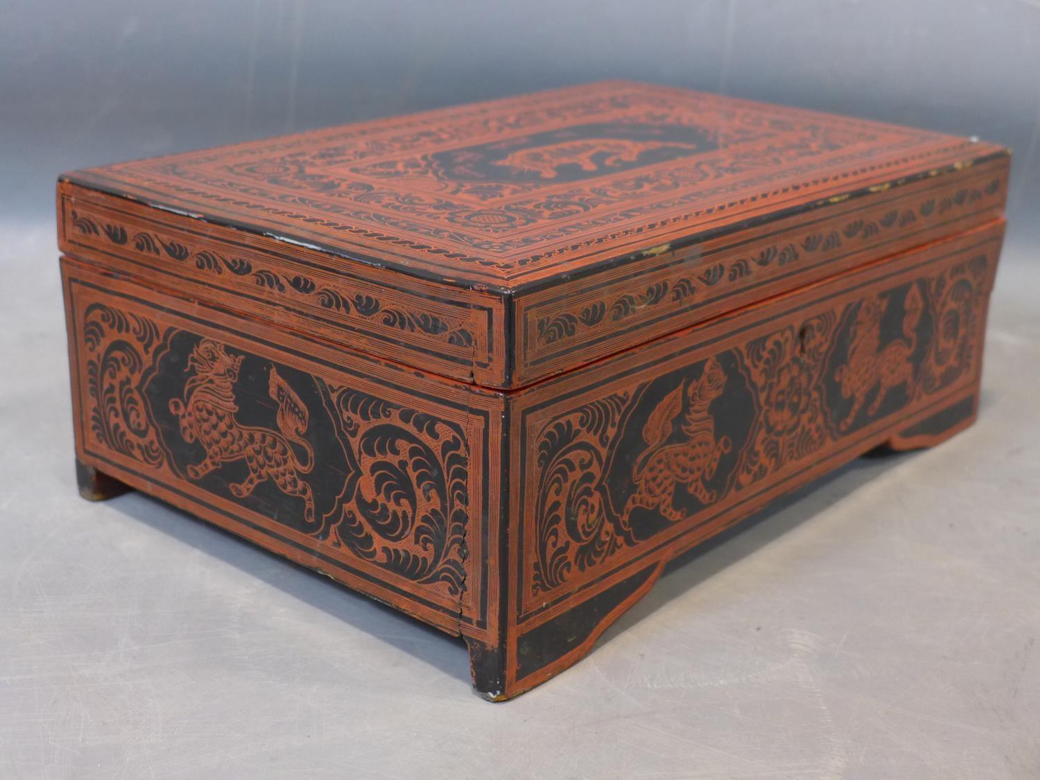 Large Burmese lacquered box richly decorated on the cover with a tiger and a Burmese inscriptions, - Image 3 of 3