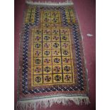 A North-East Persian Beluchi rug, with repeating petal motifs on a brown ground, within geometric
