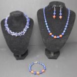 A lapis lazuli necklace, together with a lapis lazuli and coral necklace with matching bracelet