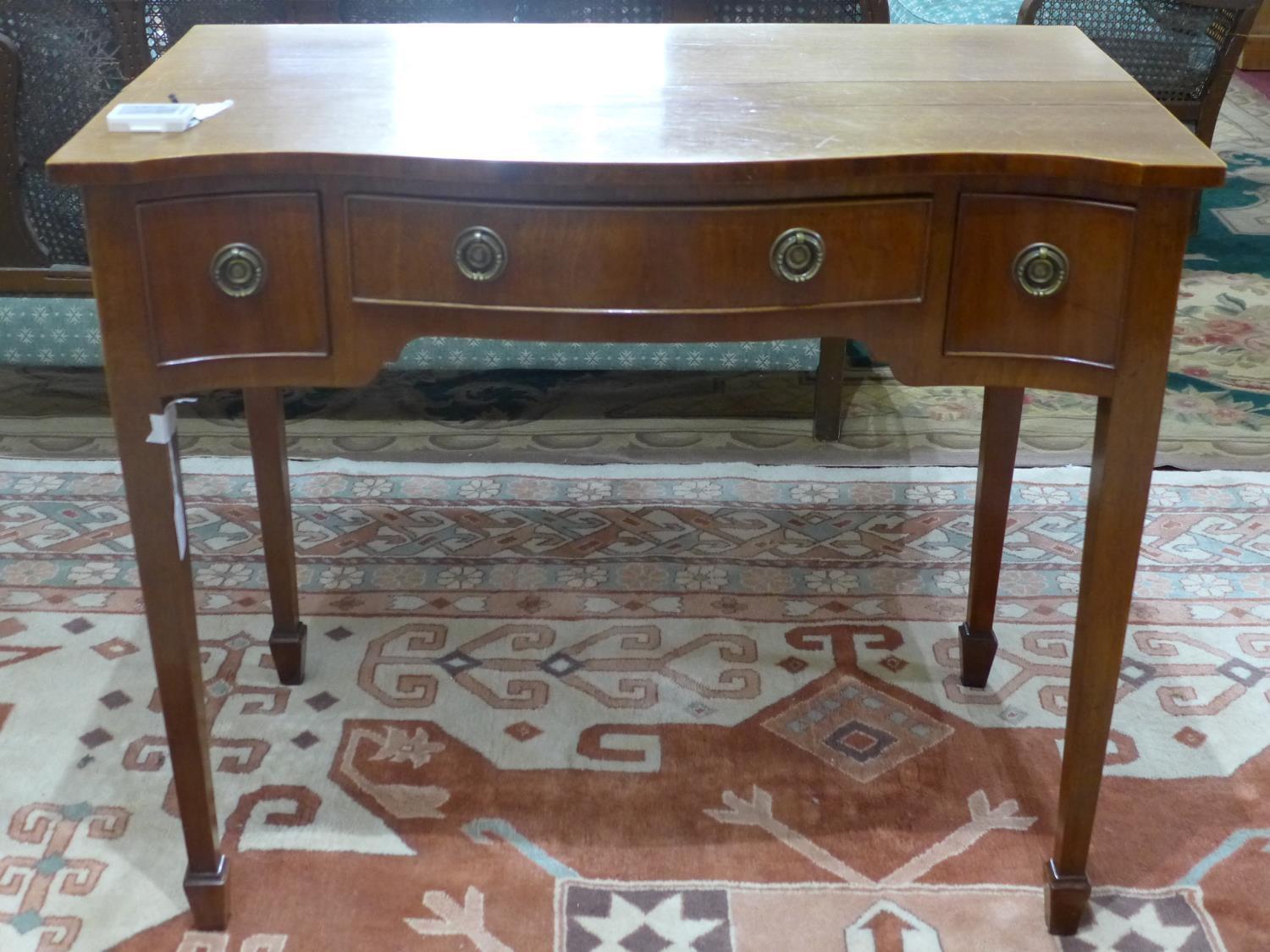 A small early 20th century desk on tapered legs
