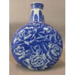 A 20th century Chinese blue and white vase, decorated with flowers on a blue ground, bearing four