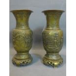 A pair of Chinese bronze vases with a frieze representing domestic scenes, 19th century H. 40 cm